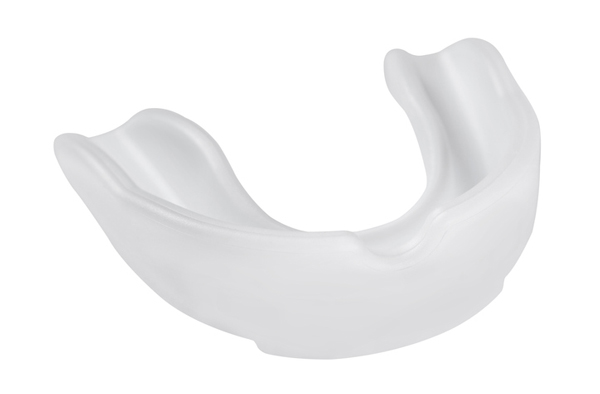 Opaque white plastic mouthguard on a white background in New York, NY